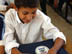 A student from the Zein Al Abdeen secondary boy's school in the Amil district of Baghdad with a calculator from his new school bag which contains, pens, pencils, notebooks, a calculator and other school supplies. USAID is funding the purchase and distribution of 1.5 million of the bags through a contract with Creative Associates International. All Iraqi secondary students will receive the bags.