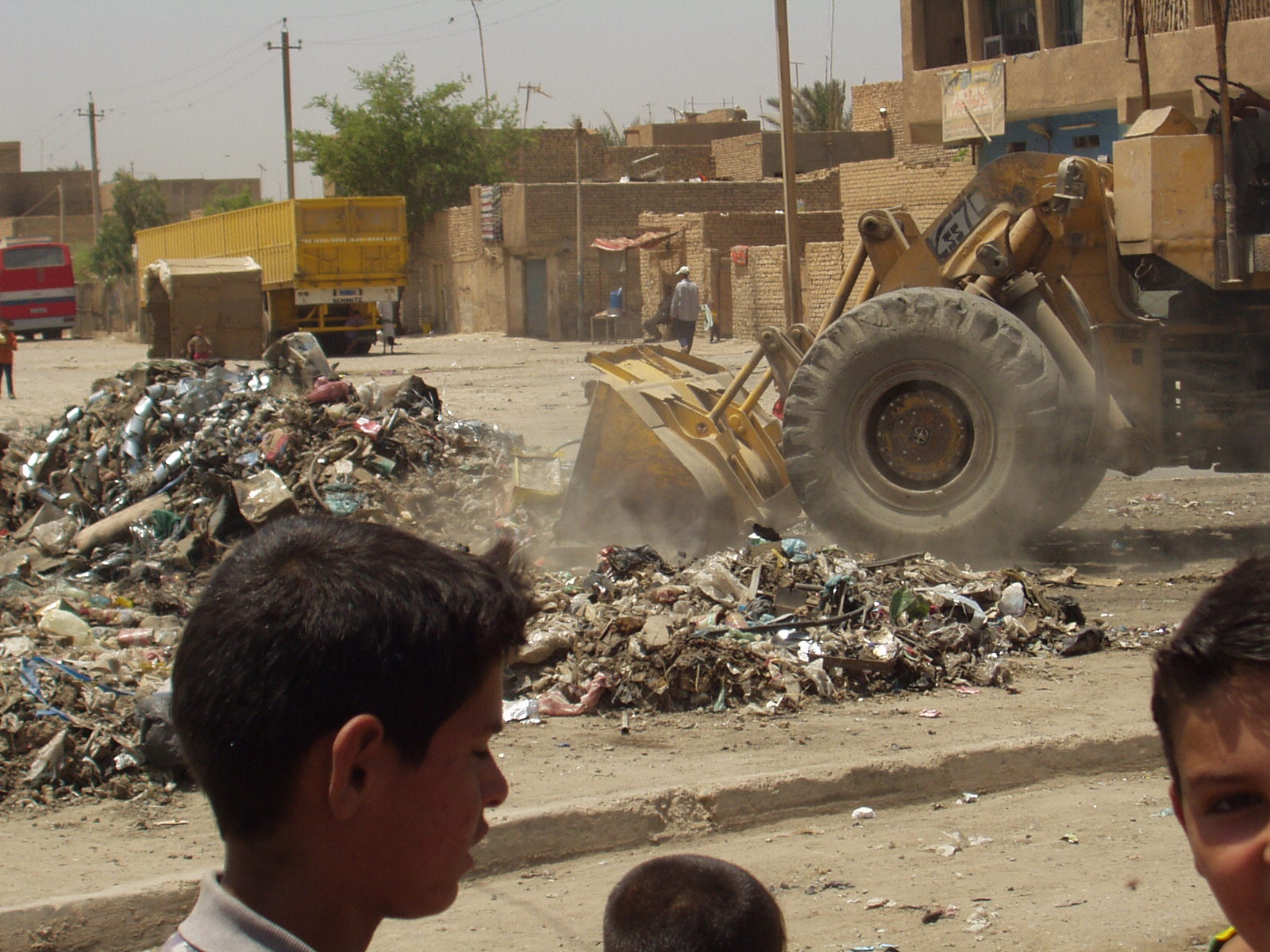 Locals watch as the OTI sponsored clean-up begins