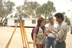 A DART Program Officer, accompanied by DART translator, listen to Abdul Khaliq, an Iraqi engineer in charge of the installation of a prefabricated building that will act as temporary headquarters for the town council in the southern Iraqi town of Umm Qasr (shown in the background.)  The building will be divided into 3-4 rooms that will enable the town council to carry out its duties in meeting the needs of the town's residents.  The building was erected under a grant from USAID's Office of Transition Initiatives.  The U.S. Government, through USAID/OTI, also provided funds to rehabilitate a secondary school in Umm Qasr, enhance telephone and Internet connectivity in the town, and to establish a sports and recreation program to keep children occupied after the end of the school year.