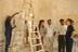 A DART Program Officerand a group of Iraqi workers and children pose outside a prefabricated building being built with U.S. funds to house the headquarters of the town council in Umm Qasr, in southern Iraq. The project is one of several quick impact projects being funded through USAID's Office of Transition Initiatives.