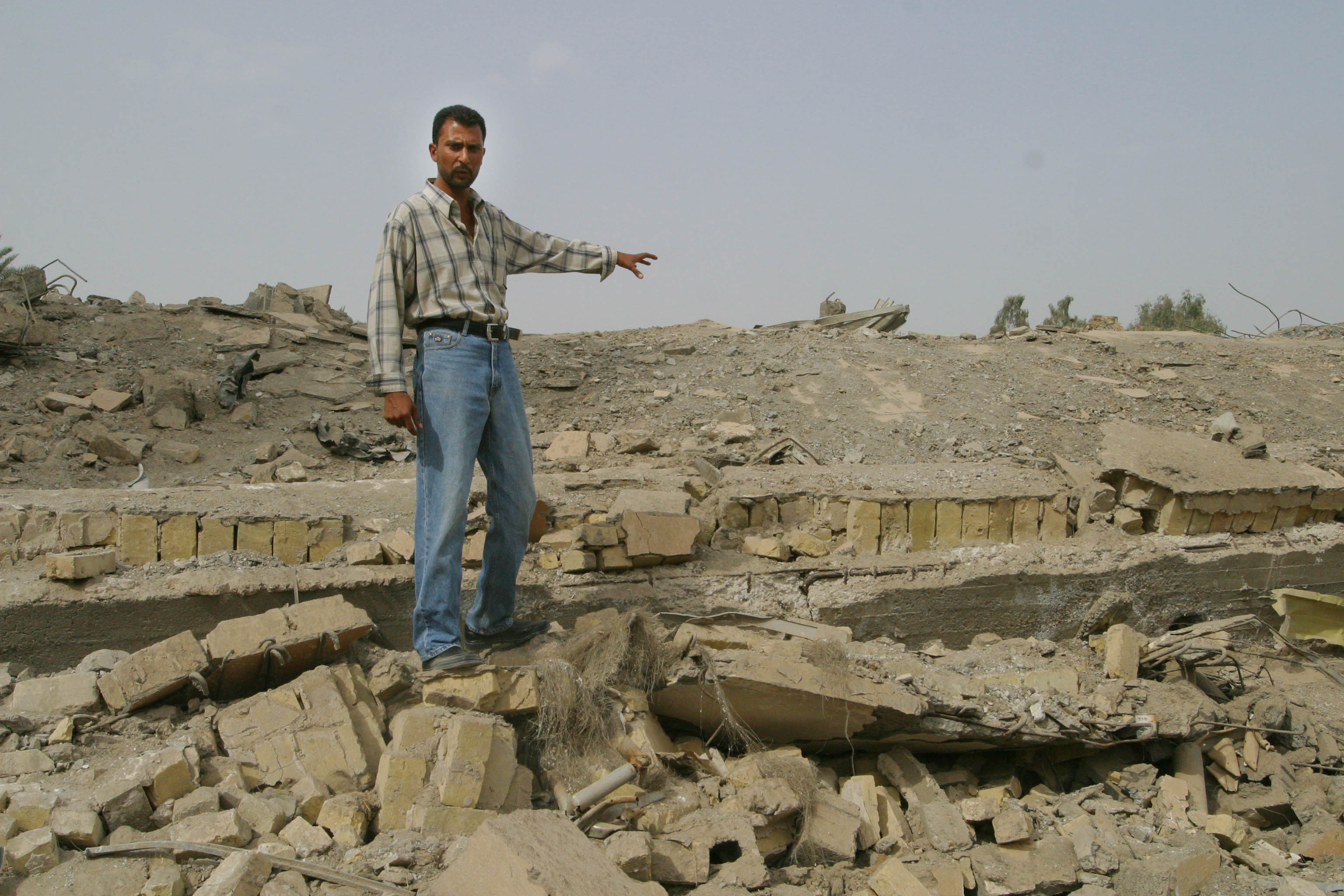 Iraqi civil engineer, Firas Al Maini, points out the site where he will supervise excavation to retrieve documents relating to telephone subscribers served by the Al-Mamoun Telephone Exchange where repair work will restore telephone services to approximately 30,000. Al-Mamoun is one of 12 telephone exchanges in the Baghdad region which were deystroyed in the recent conflict.  USAID partner Bechtel is working with the Iraqi Telephone and Postal Company to restore landline telephone service and provide a gateway for international telephone service. Iraqi workers begin to splice cables into the new exchange. The first international telephone call through the new Al-Mamoun exchange is scheduled for 23 October, 2003.