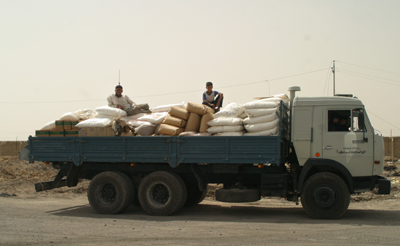 Food aid leaves a World Food Program warehouse in Umm Qasr, southern Iraq. USAID supports the program which provides basic food rations to a large number of needy families in Southern Iraq.