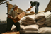 Workers load food supplies from a World Food Program warehouse in Umm Qasr, for distribution through local neighborhood agents. USAID supports the program which provides basic food rations to a large number of needy families in Southern Iraq.