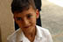 An Iraqi boy waits after school at the Rams Al Umma school in the Saydiya neighborhood of Baghdad. Several rooms of the school were looted during the war. USAID is looking at refurbishing the school.