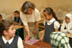 A USAID Education advisor talks to Iraqi school girls about their curriculum at the Agadir Secondary school in the Saydiya neighborhood of Baghdad. USAID is looking at funding efforts to update the Iraqi school curriculum.