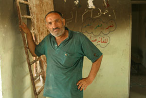 A guard stands in a classroom in the Basra Intermediate School for Boys that was looted and burned in the war. USAID is rebuilding numerous schools in the country.