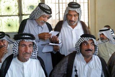 Mokhtars from Abu Ghrayek, 1 of 15 subdistricts of the Babel Governate, listen to a description of the basics of democracy and the selection process that will allow for delegates to select 20 members from their communities to a new district council. USAID is working to promote ongoing  local governence projects throughout Iraq. 