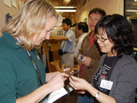 Nancy Dewitt and a scientist inspect a fiberglass-resin cast of a crab burrow