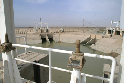Two storage reservoirs of the Sweet Water Canal  control flow of fresh water downstream. The project supplies all the fresh water to the city of Basrah and environs. The serpentine walls within the reservoir are designed to slow the flow of water allowing solids to settle  providing cleaner water to water treatment  plants downstream. The 275km canal, storage reservoir and pumping stations have suffered from a lack of maintenance and will be rehabilitated by USAID partner Bechtel at a cost of almost $12 milllion. When completed by March 1, 2004 it will serve 1.75 million citizens of the Basrah region.