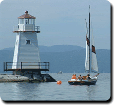Photo of lighthouse and sailboat on Lake Champlain
