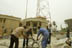 Workers repair damage to the Iraqi Media Network in central Baghdad that suffered from bombing and looting. The network has been broadcasting independent TV since 12 May, 2003 for an average of 3 hours a day using a portable transmission dish. Eventually the tower shown will becme operational. USAID is funding refurbishment of facilities and supply of air conditioning, telecommunications and office equipment.