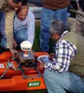 Scientists and engineers from the Iraq Ministry of Water Resources learn to use an acoustic Doppler current profiler, a device used to measure water velocities over a range of depths. Photo Credit: Steve Lipscomb, USGS