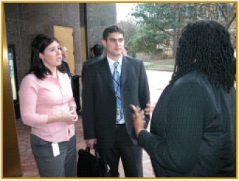 photo of 3 people talking in lobby