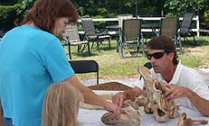 Jim Reid explains the features of manatee bones to Open House visitors