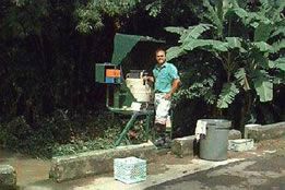 Photo - USGS Hydrologic Technician Angel Torres removing samples from automatic water sampler at the Canóvanas river station, near Canóvanas, Puerto Rico. Click for larger photo