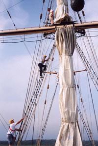 Jamey Reid and Joseph Reidy climb the ship’s rigging.