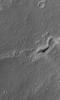 This MOC image shows the inverted, eroded remains of a channel, now standing as a complex ridge that runs across the middle of this scene, in dust-mantled terrain west of Sinus Meridiani, Mars