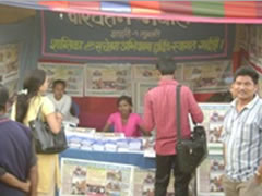 Visitors receive information on the CPA at the 'Peace Stall' at a commercial fair in Itahari, Sunsari District.