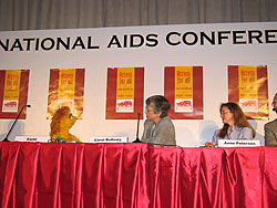 Photo of Dr. E. Anne Peterson participating in a press conference to launch the 2004 report titled Children on the Brink, which outlines the global condition of orphans and vulnerable children affected by HIV/AIDS. Left to Right (“Kami”, Sesame Street; Carol Bellamy, UNICEF; E. Anne Peterson, USAID). Photo Credit: Roslyn Matthews (USAID/LPA)