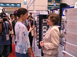 Photo of Actress Ashley Judd visiting with Dr. Constance A. Carrino (USAID) at the U.S. government booth. Photo Credit: Clare Hayden (SSS/The Synergy Project)