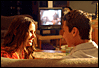teen boy and girl in front of TV