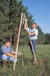 Engineer and technician take a deep soil sample from the edge of a buffer system: Click here for full photo caption.