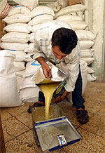 Photo Credit: USAID. A man works in a food storage area.