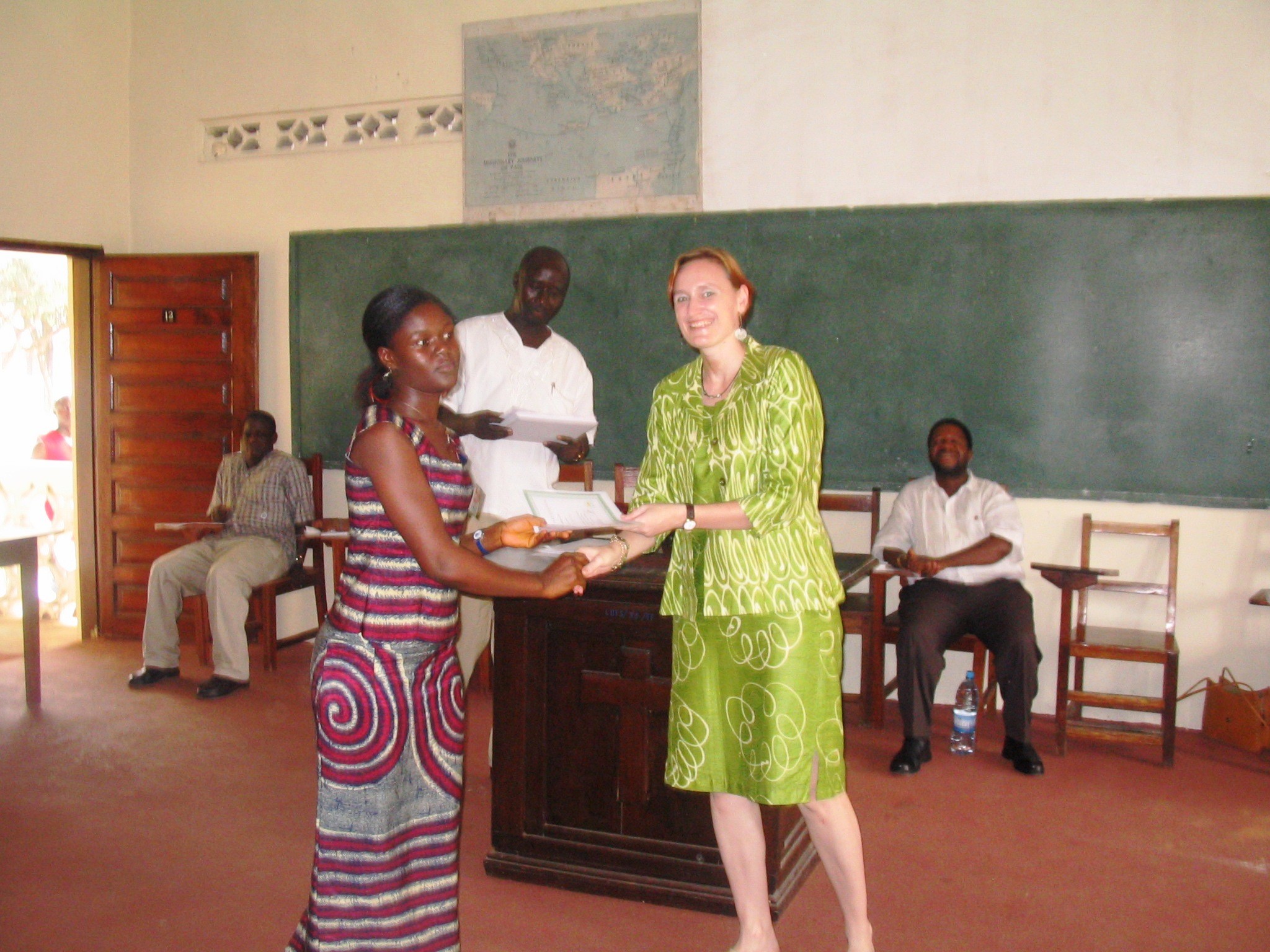 Photo: Community Peace Education Facilitator receives training certificate from LTI.  
.