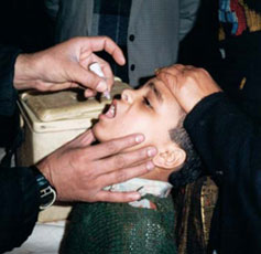 Photo of a young child receiving oral polio vaccine.