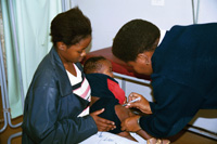 Nurse vaccinating a baby