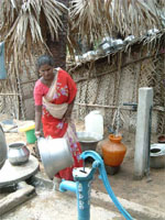 Woman using clean water at Cuddalore temporary settlement. Photo: USAID/ Ebony Bostic