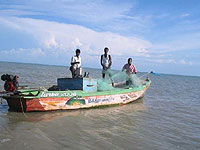 Fishermen in repaired boat -  Photo: Project Concern International/India