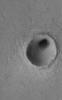 This MOC image shows some a modest-sized meteor impact crater in the Elysium Planitia region of Mars. The dark spot inside the crater is, most likely, a patch of windblown sand and silt