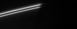 Bright strands in Saturn's ever changing F ring emerge from the planet's shadow. The F ring usually has a single bright core, about 50 kilometers (31 miles) across, but the section of the ring seen here appears to have a second bright strand