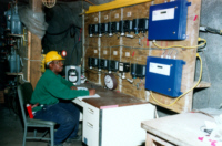 Researcher monitors instrumentation for analyzing toxic fumes produced by a blasting agent detonated in the chamber