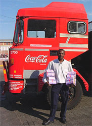 Photo of a driver for United Bottlers, one of Coca-Cola’s main bottlers in Zimbabwe, loading Protector Plus on his truck before a road trip.