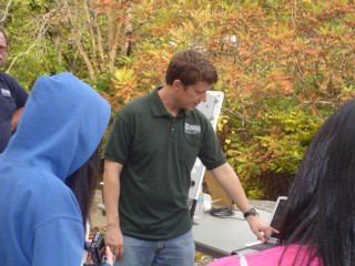 A USGS employee explains stream-gaging equipment to high school science students from Perth Amboy and other attendees.