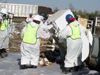 EPA workers prepare appliances for recycling. 