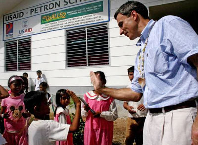 Children of Tawi-Tawi, Mindanao and US Deputy Chief of Mission to the Philippines Paul Jones, celebrate the inauguration and opening of a new two-room classroom, built by USAID and Petron Fdn