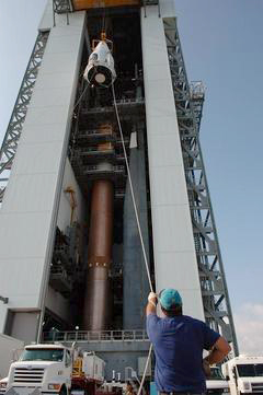 The Mars Reconnaissance Orbiter, inside its protective fairing, is raised to the top of the Atlas V rocket.