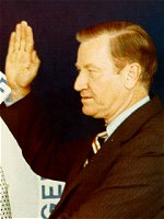 Photo of Russell Train's swear-in. Left-to-right: Elliot Richardson, Aileen Train, and Russell Train