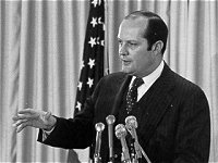 Photo of Douglas Costle speaking at a podium