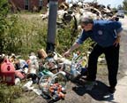 Richard Greene shows GAO visitors an example of homeowner segregation of household hazardous waste curbside in St. Bernard Parish