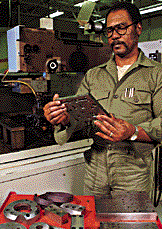 Man checking output of die cutting machine