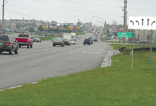 Photo: M-11 Facing West with a sign showing dual left turn, dual through and one right turn.