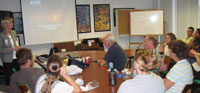 Lisa Robbins addresses a crowded conference room