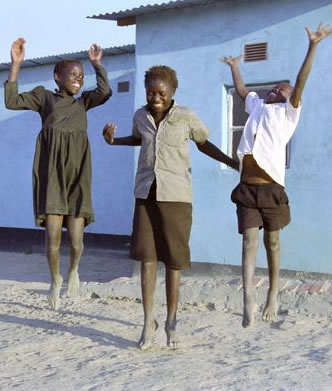 Children Celebrating as they receive visitors from USAID Zambia visitng their area Southern province. Photo: Jon Warren/World Vision