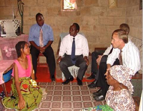 Senefa Chinga, 43, who is on antiretroviral drugs shares her story with Dr. Ben Chirwa (center), Director-General of Zambia’s National AIDS Council and Ambassador Mark Dybul, U.S. Global AIDS Coordinator, during their visit to Chazanga Compound, Lusaka, in October 2006. (PHOTO: USAID/Renuka Naj)