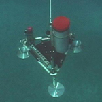 Image of rotating sediment trap being lowered into position.