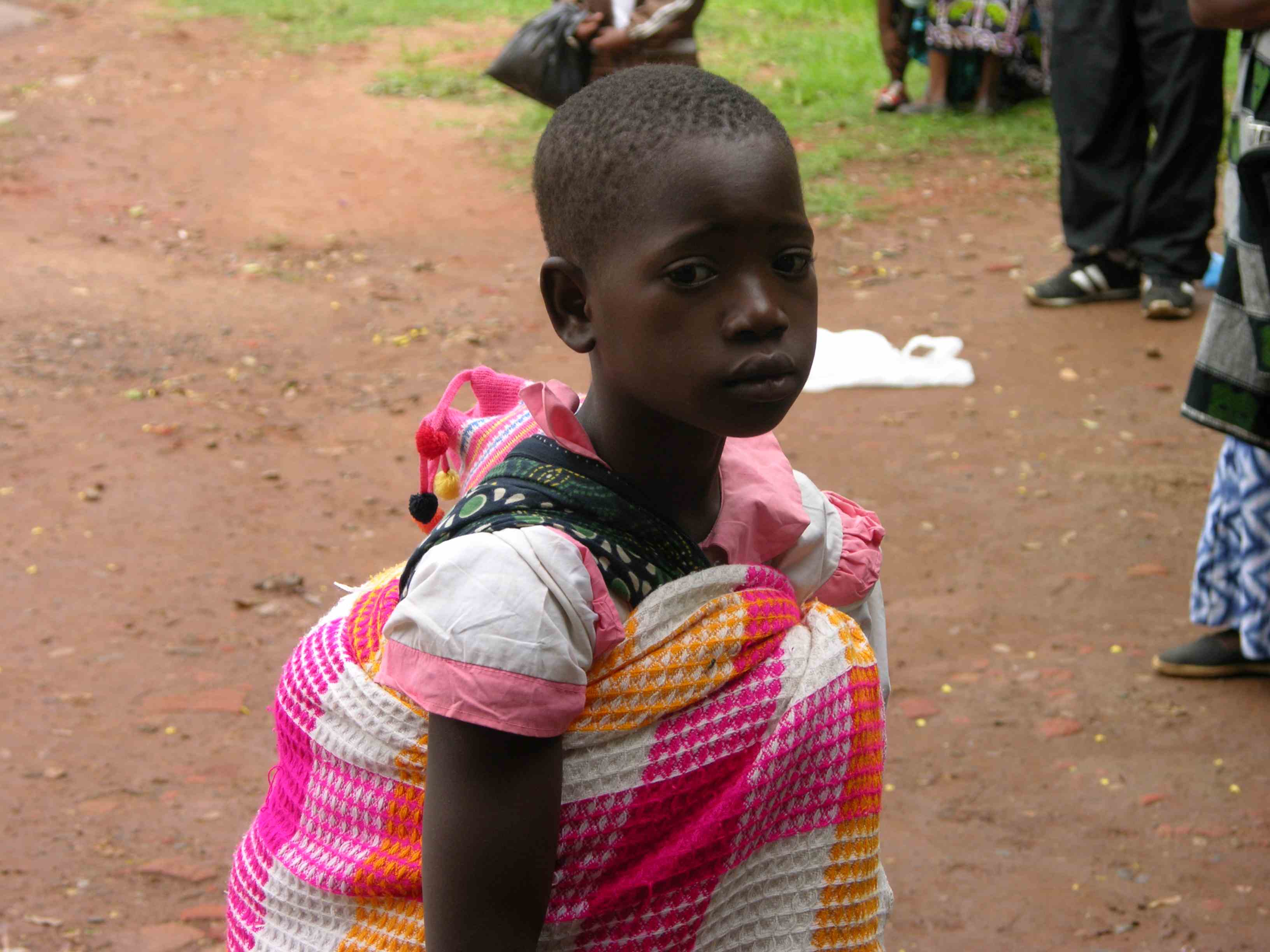 Girl at Kamuzu Central Hospital with a baby on her back (Photo by: Anna Sparks)